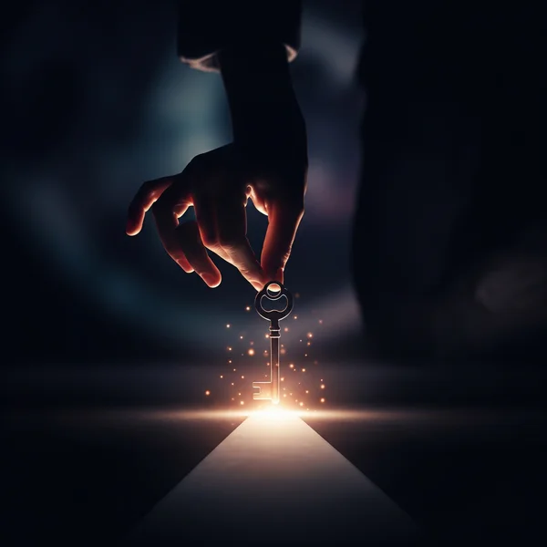 A hand holding a glowing key, symbolizing finding a solution.