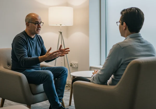 Person talking to a therapist, seeking professional help